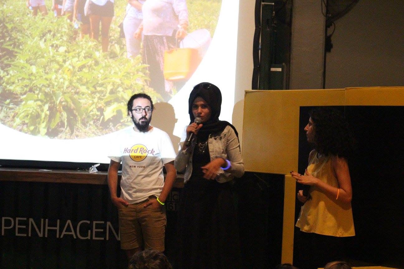 Two presenters on stage introducing a topic to the group